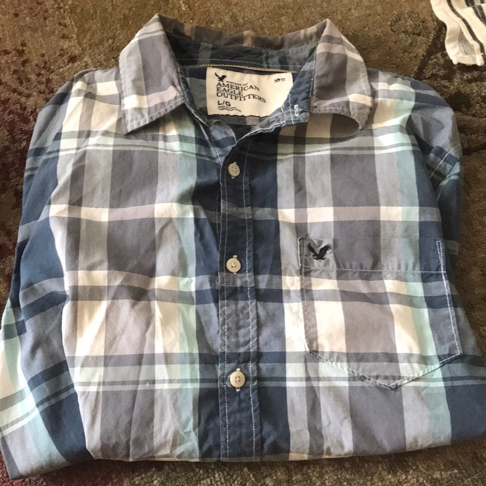 A pair of men’s long sleeve button down.